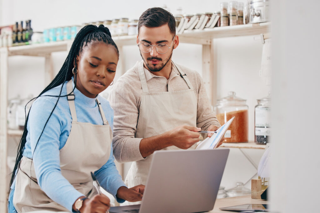 employees using a laptop in a retail setting